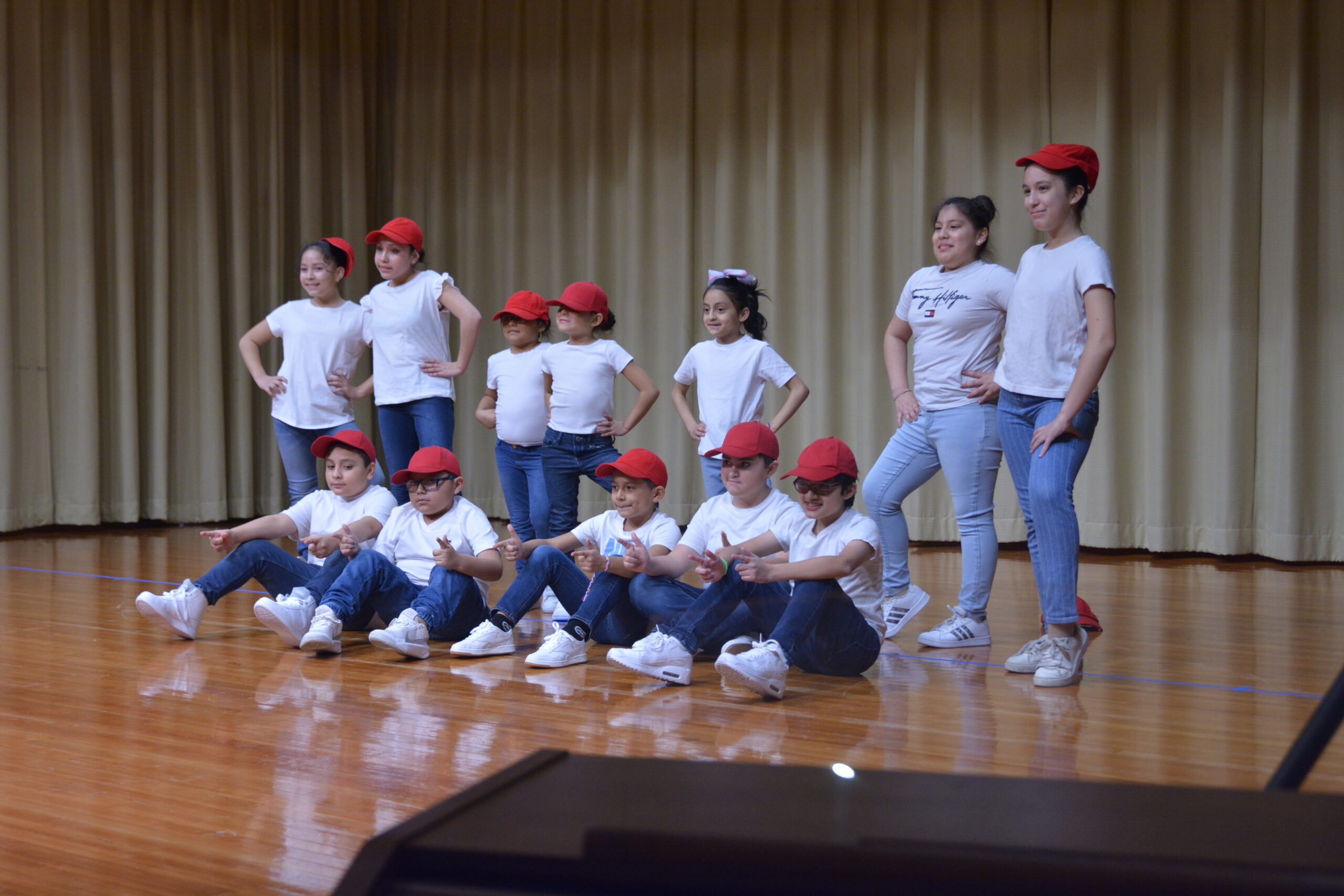 Group of kids posing on stage