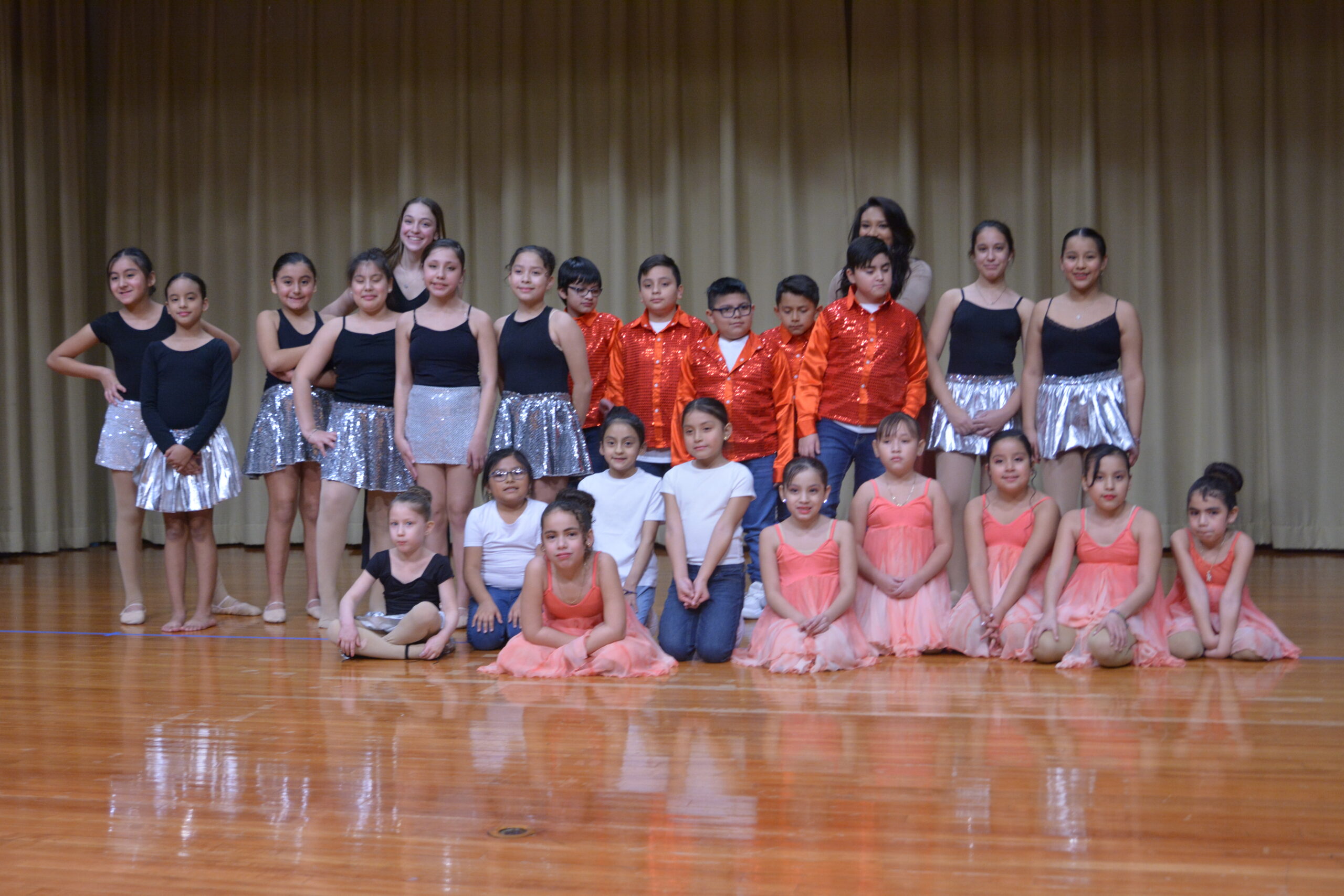 Group of kids posing on stage